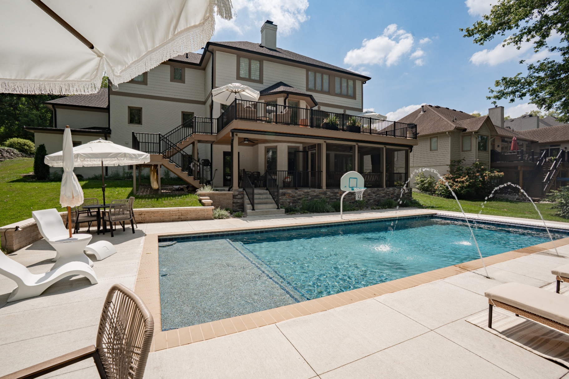 Wide-angle view of a composite deck with a screened porch and pool in Indianapolis