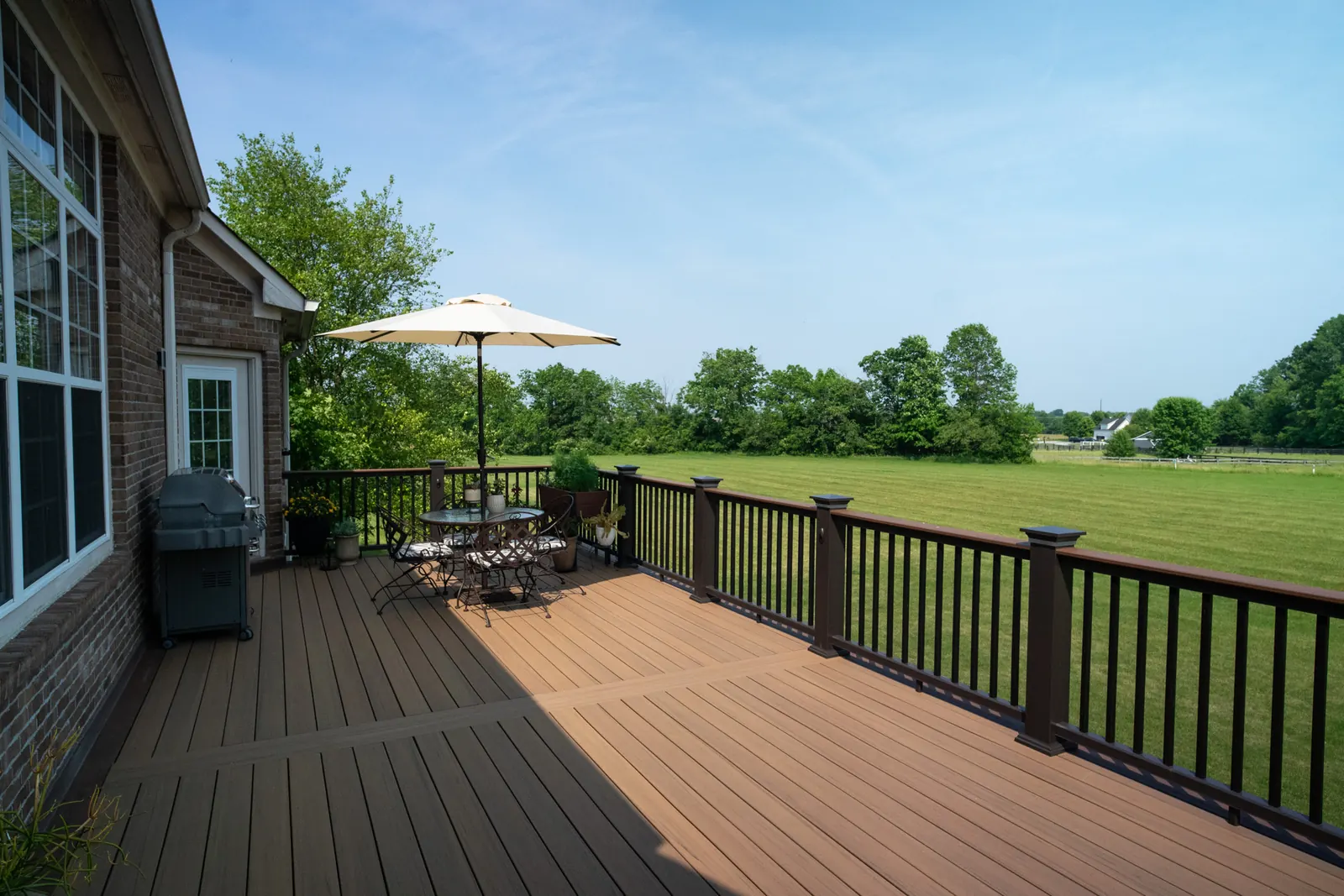 Composite deck with overlook view, table, and grill in Westfield.