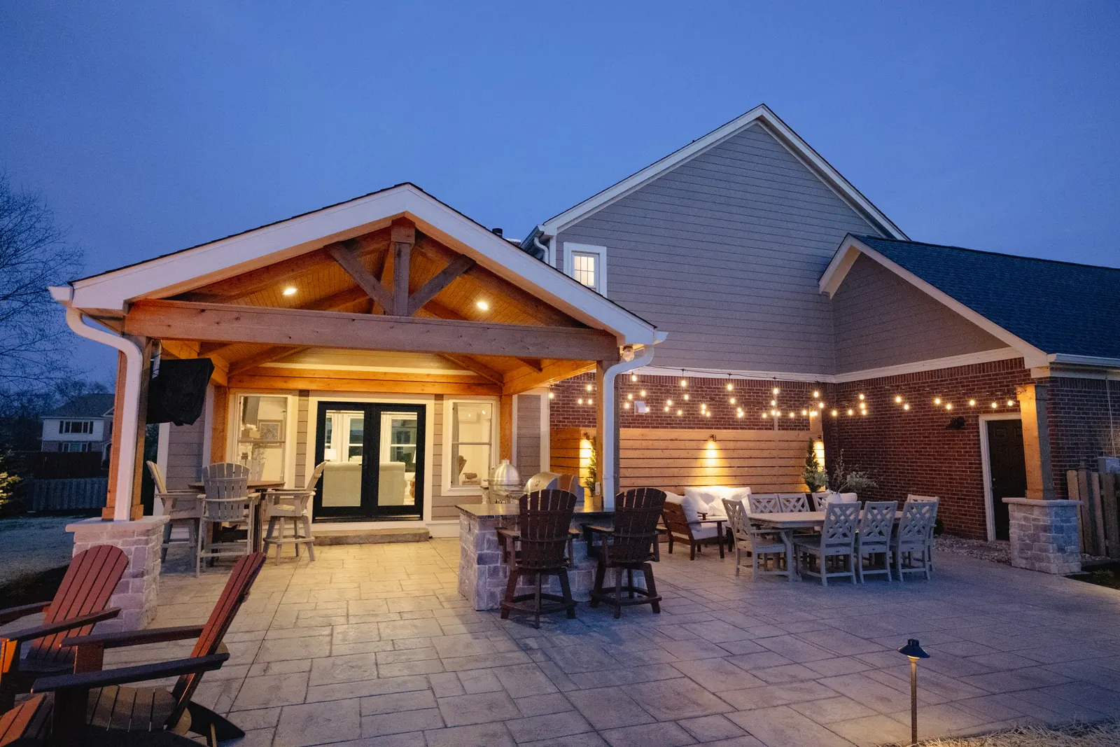Attached outdoor structure with kitchen and patio dining table in Carmel.