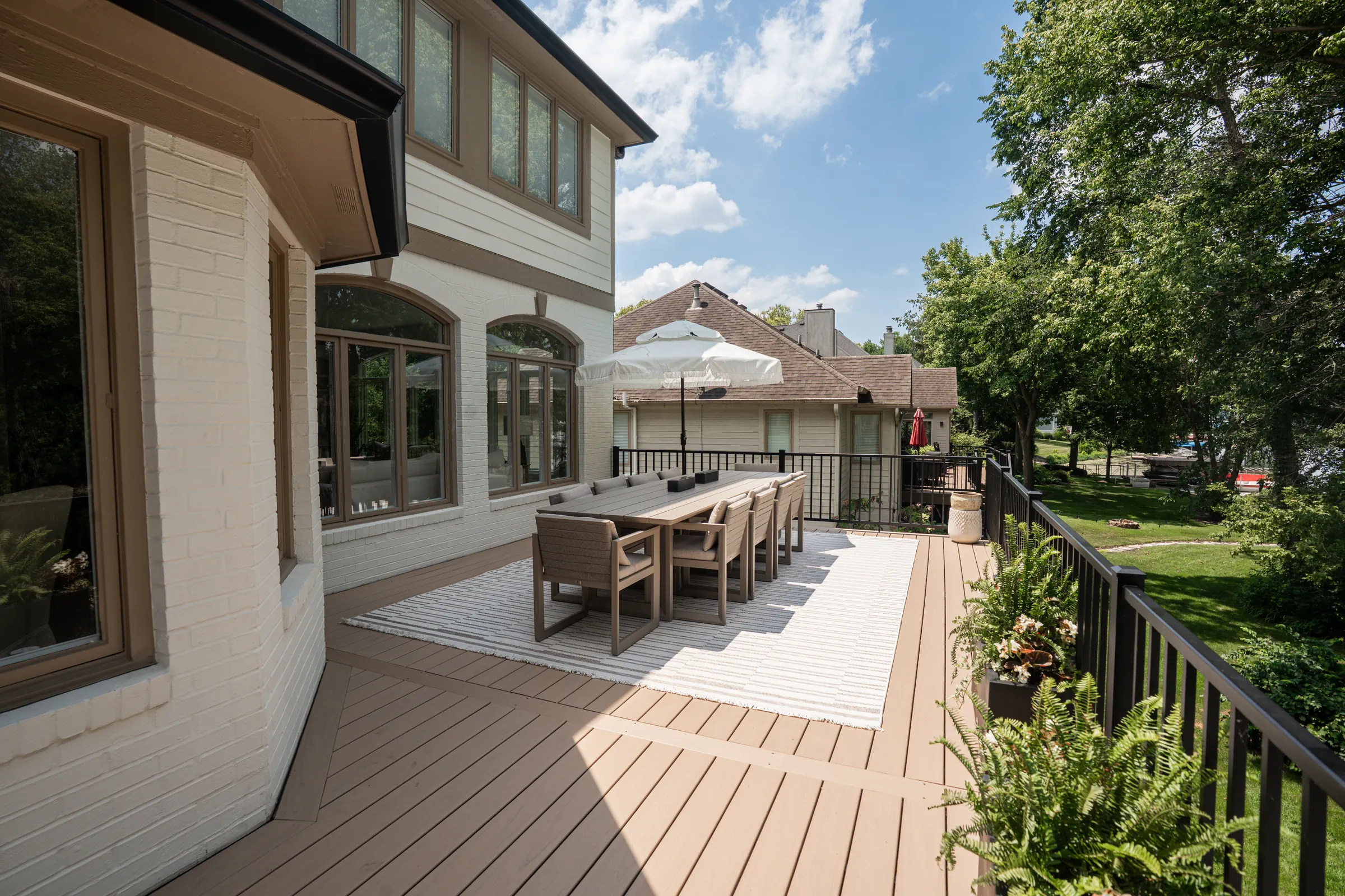 Composite deck outdoor dining space in Indianapolis, pressure-treated cable rail.