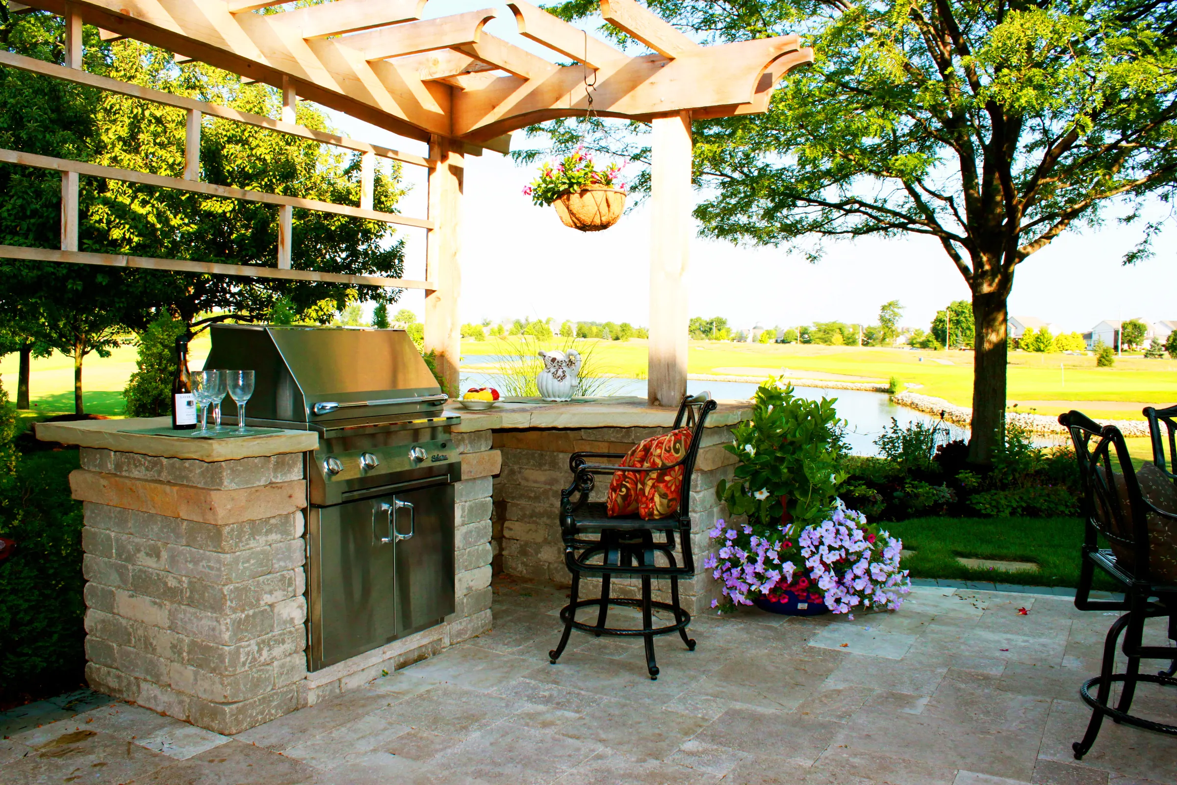 Outdoor kitchen grill block view flowers.