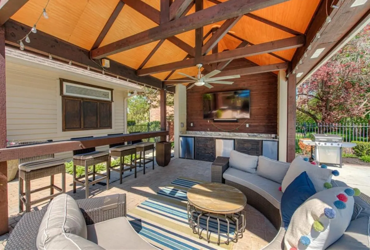 Outdoor living with pool, pavilion, entertainment center, and lounge.